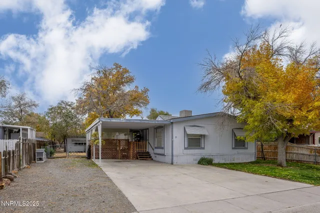 a view of a house with a patio and a yard