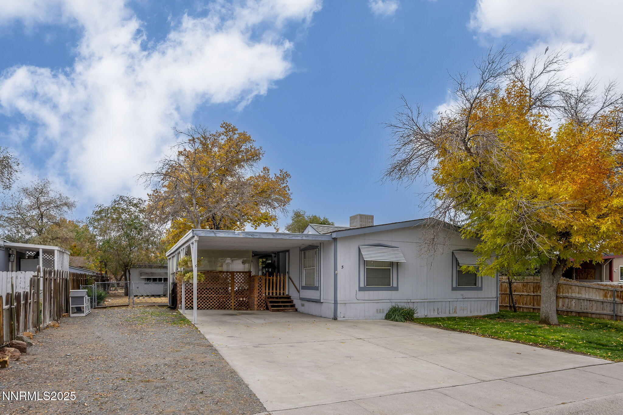 a view of a house with a patio and a yard