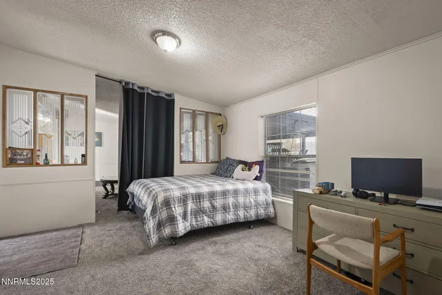 a bedroom with bed and window