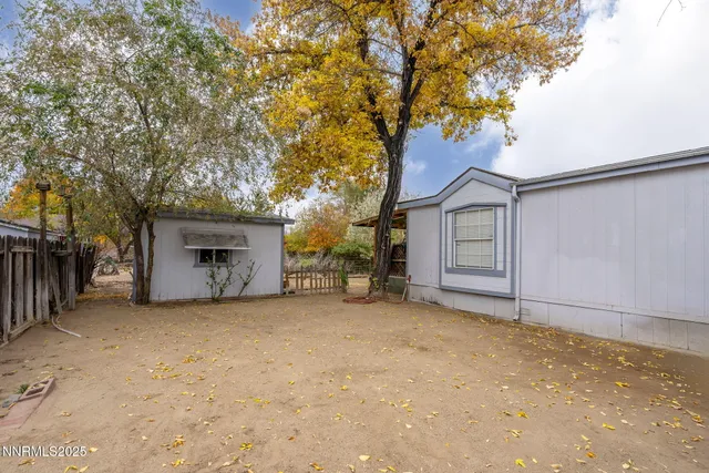 a view of a house with a tree in front of it