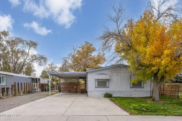a view of a house with a yard and tree