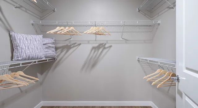 a view of walk in closet with clothes