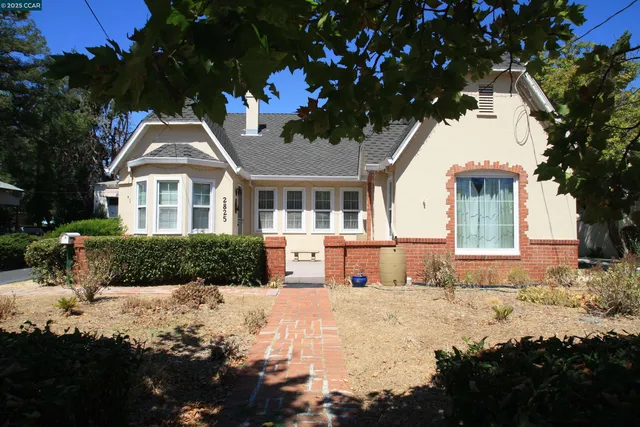 a front view of a house with a yard covered with snow