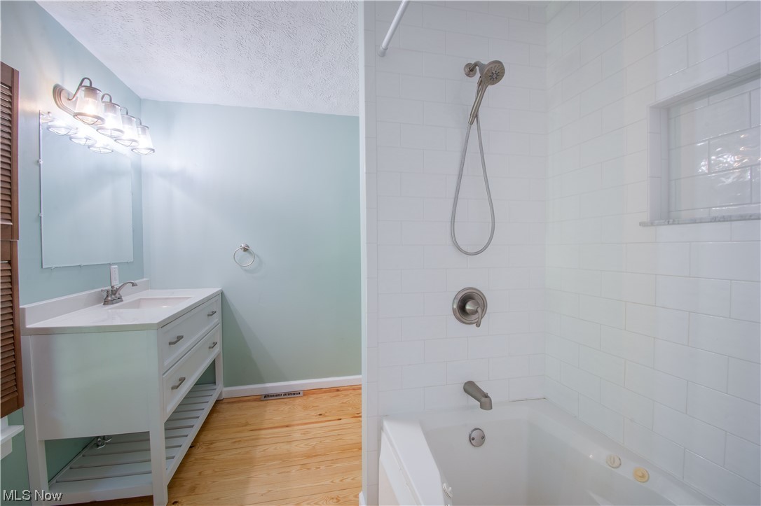 6399 Ridge Road Wadsworth, OH 44281 - Photo 27 of 32 A full bathroom with a large vanity, and a jetted tub.