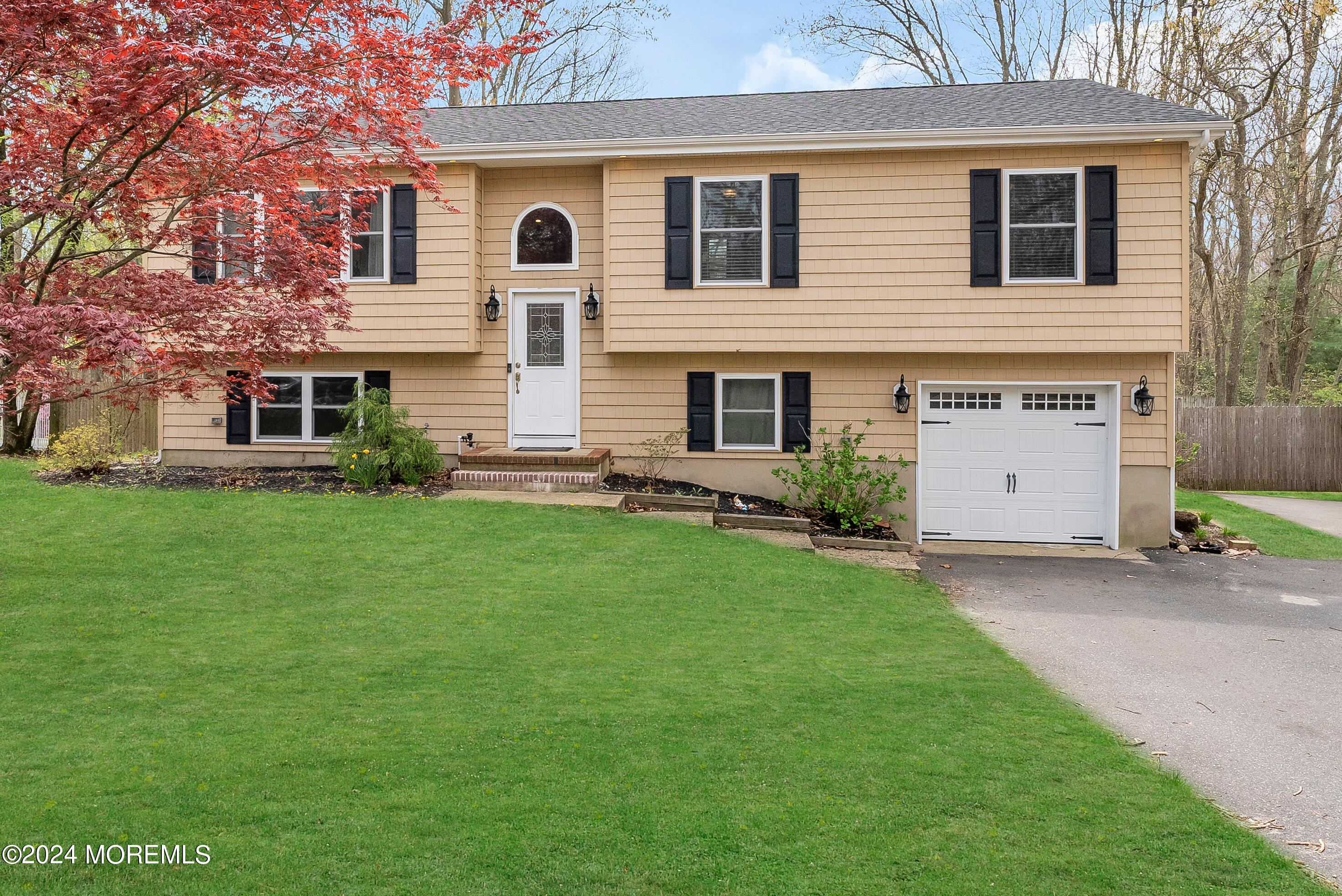877 Hyson Road Jackson, NJ 08527 - Photo 1 of 35 a front view of a house with a garden and yard