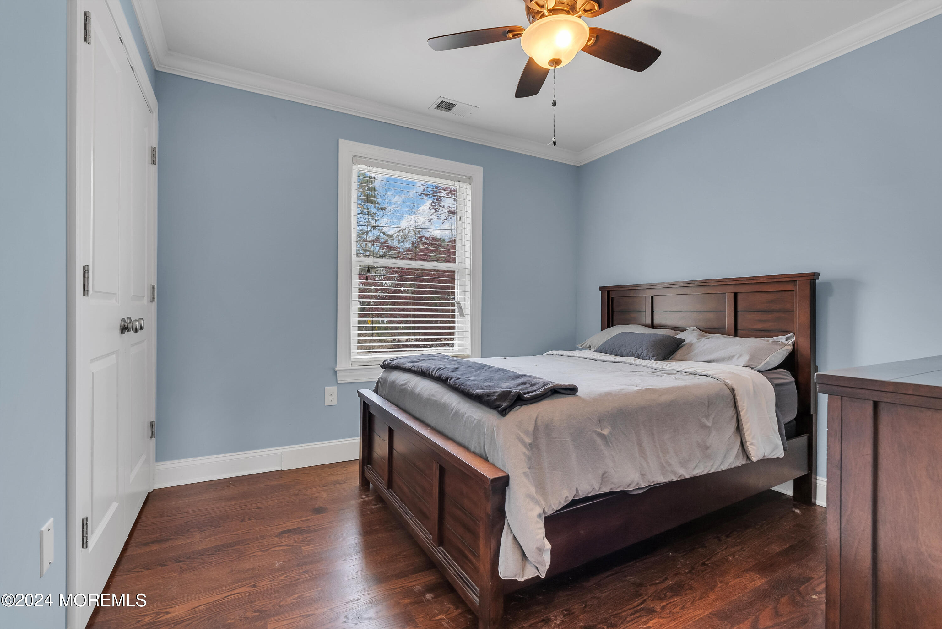 877 Hyson Road Jackson, NJ 08527 - Photo 12 of 35 a bedroom with a bed and a chandelier