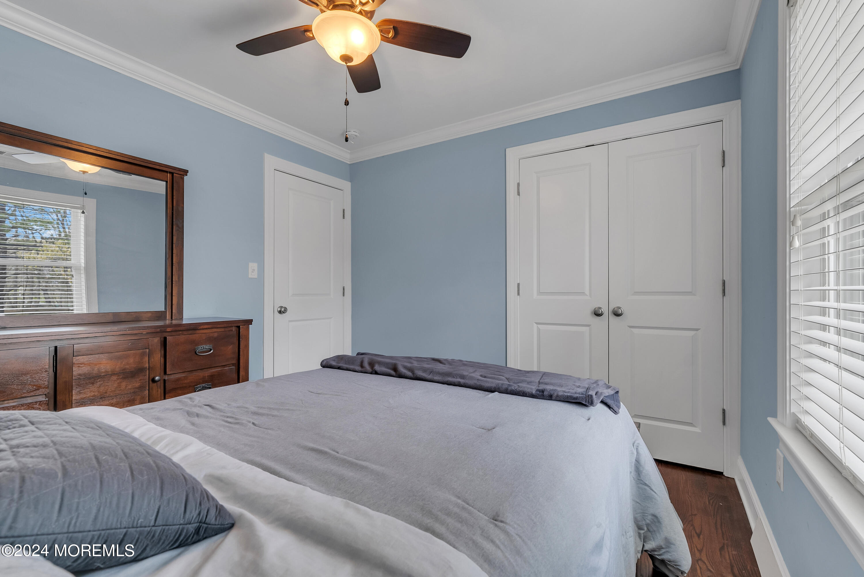 877 Hyson Road Jackson, NJ 08527 - Photo 13 of 35 a bedroom with a large bed and a chandelier