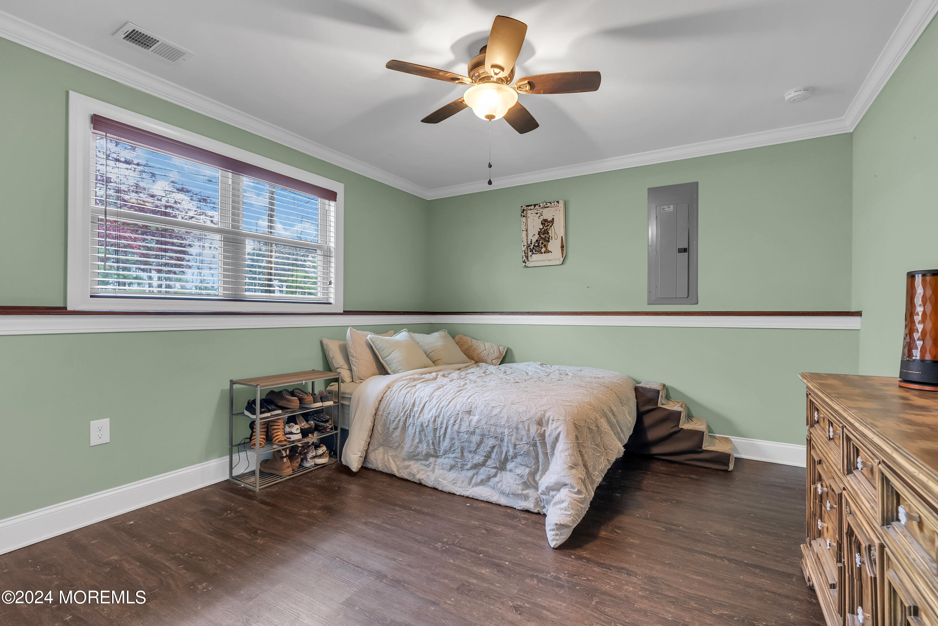 877 Hyson Road Jackson, NJ 08527 - Photo 25 of 35 a bedroom with a bed and a chandelier