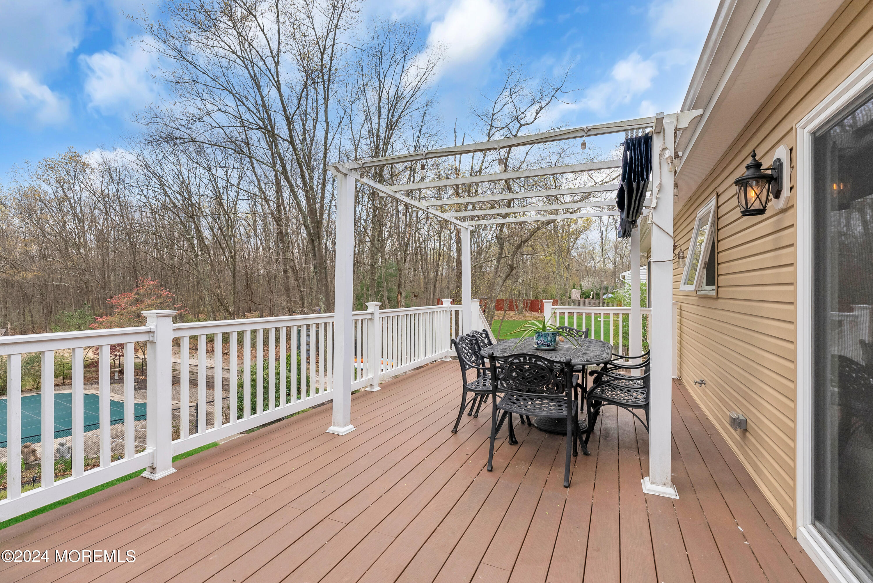 877 Hyson Road Jackson, NJ 08527 - Photo 34 of 35 a view of a deck with table and chairs and wooden floor
