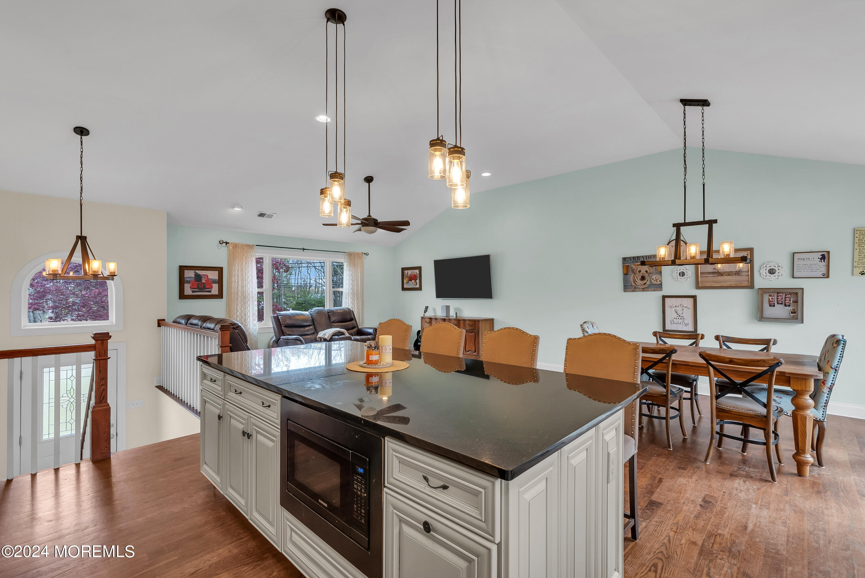 877 Hyson Road Jackson, NJ 08527 - Photo 6 of 35 a view of a dining room and livingroom with furniture wooden floor a chandelier