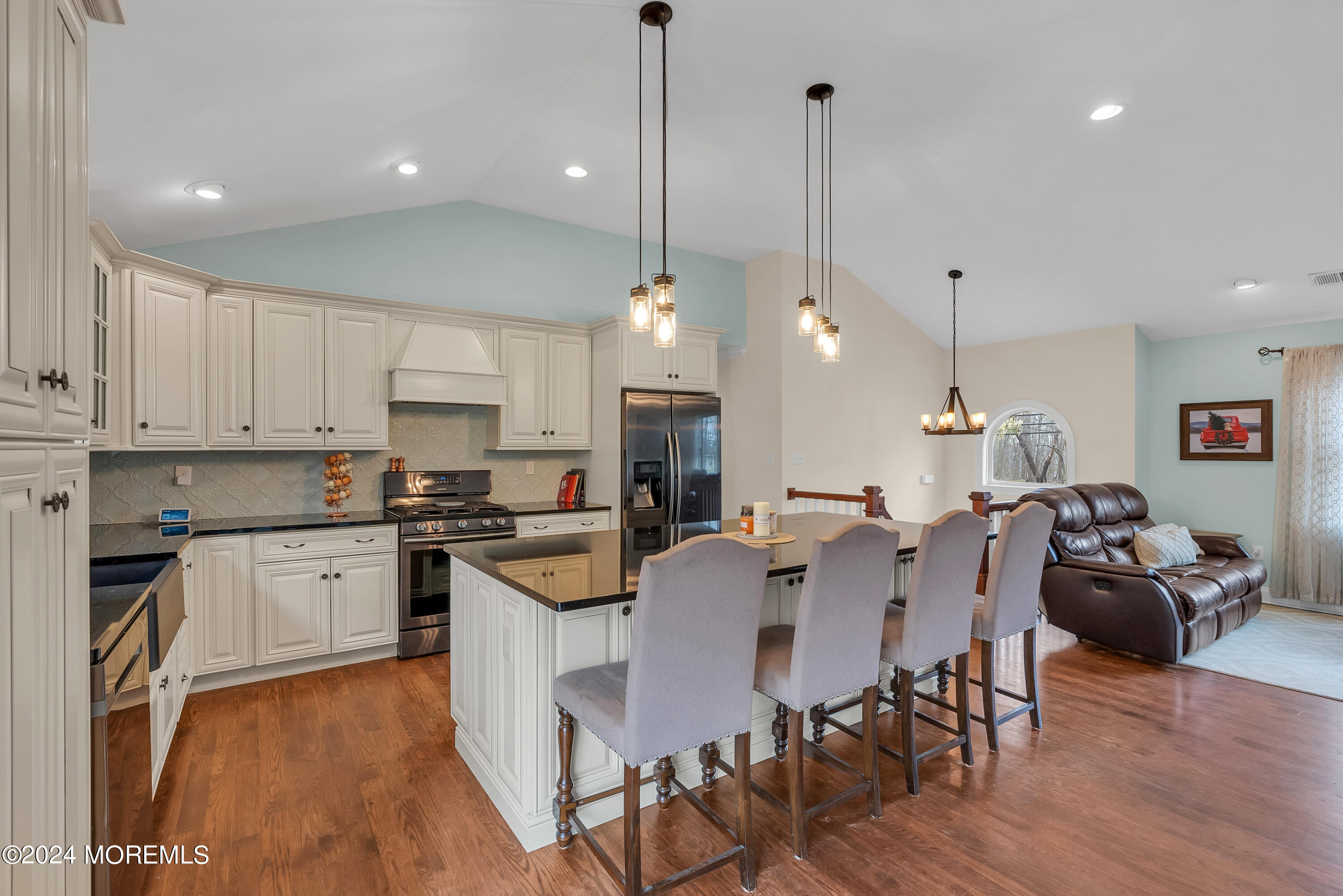 877 Hyson Road Jackson, NJ 08527 - Photo 7 of 35 a large kitchen with kitchen island a dining table chairs and a wooden floor