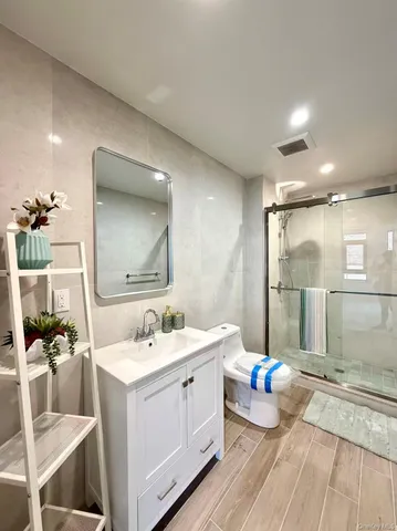a spacious bathroom with a double vanity sink a mirror and a shower