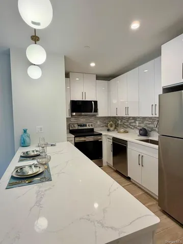 a kitchen with a white stove top oven and cabinets