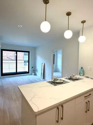 a kitchen with a table and chandelier