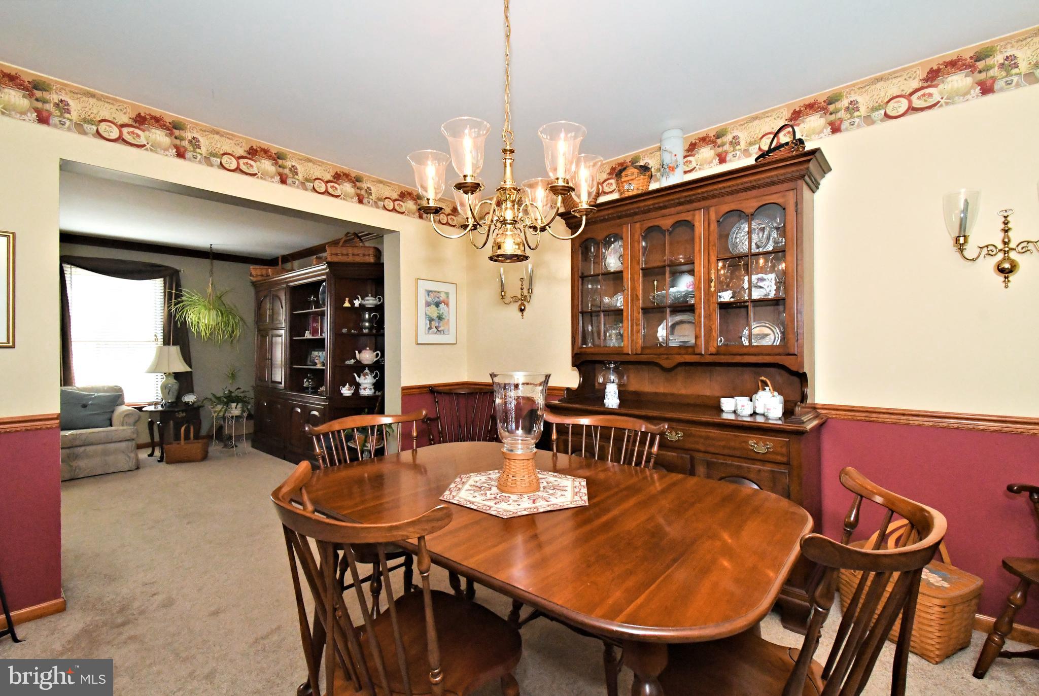 700 Alexander Drive Hatfield, PA 19440 - Photo 13 of 57 a view of a dining room with furniture and a chandelier