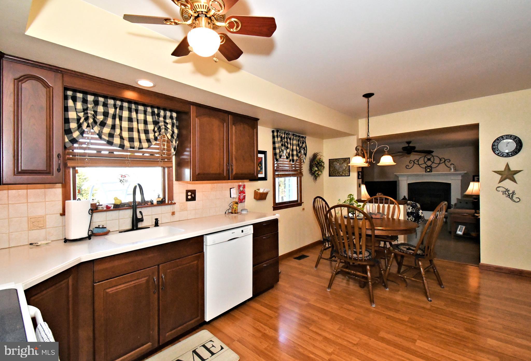 700 Alexander Drive Hatfield, PA 19440 - Photo 14 of 57 a kitchen with stainless steel appliances a dining table chairs and wooden floor