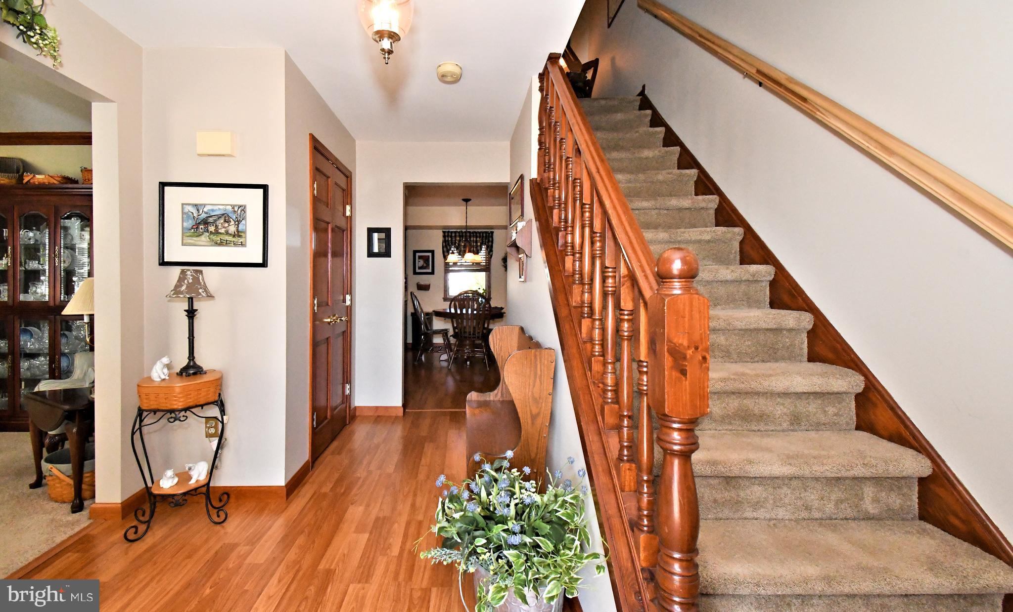 700 Alexander Drive Hatfield, PA 19440 - Photo 6 of 57 a view of staircase with lots of frames on wall and a wooden floor