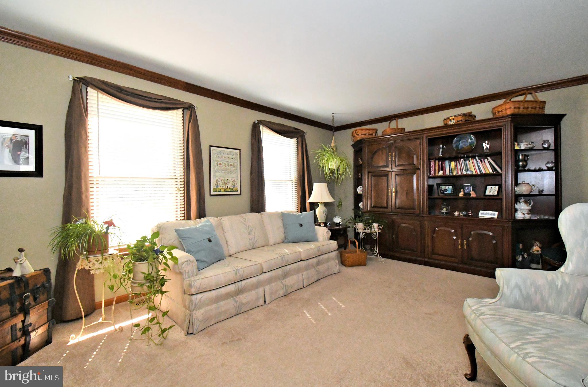 700 Alexander Drive Hatfield, PA 19440 - Photo 8 of 57 a living room with furniture and a large window with garden view