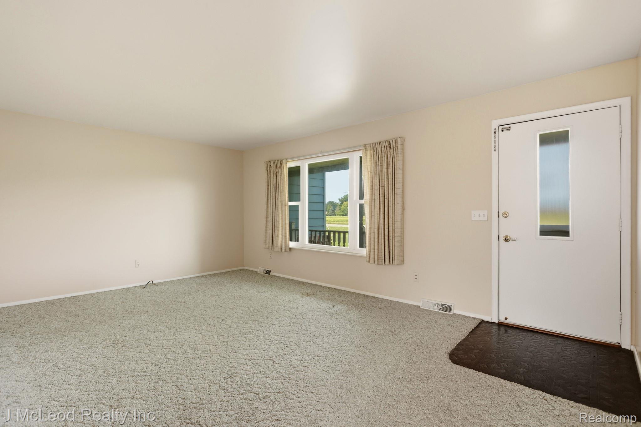 9481 Swaffer Road Vassar, MI 48768 - Photo 7 of 39 Neutral-toned walls complement the light-colored carpet flooring
