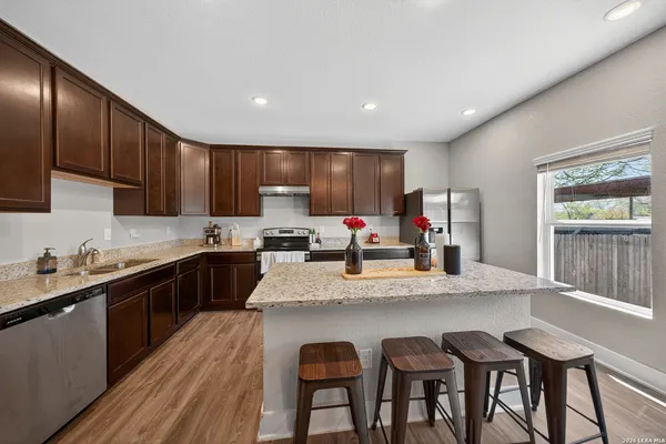 a kitchen with granite countertop a sink and cabinets