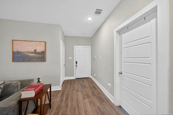 a view of a hallway with wooden floor