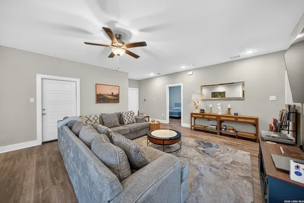 a living room with furniture and a wooden floor