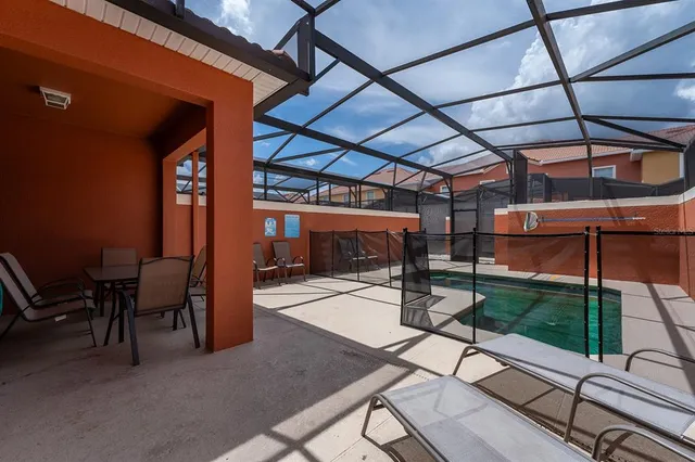 a view of a patio with table and chairs potted plants with wooden floor