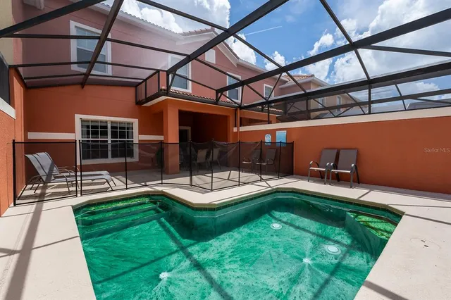 a view of a backyard with sitting area