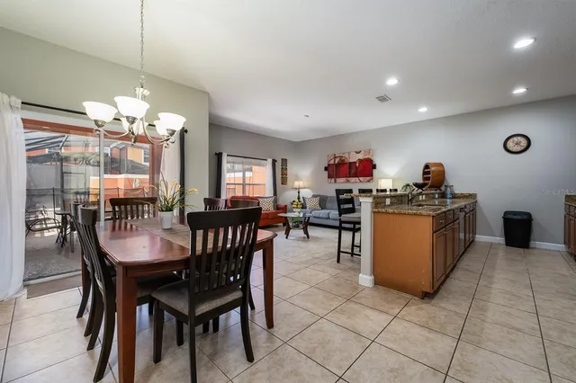 a view of a dining room with furniture and chandelier