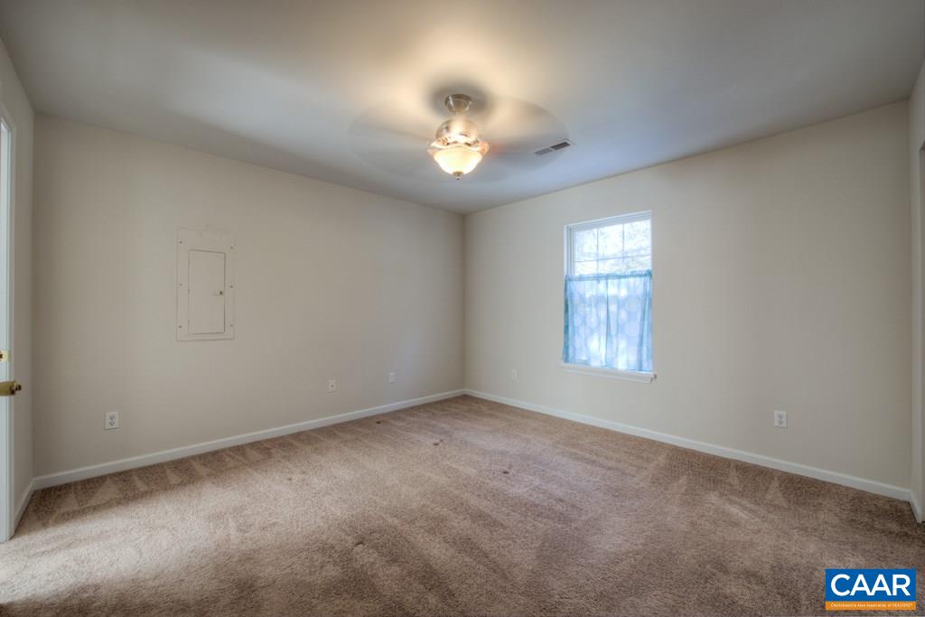 296 Morning Glory Road Ruckersville, VA 22968 - Photo 15 of 27 an empty room with a ceiling fan and window