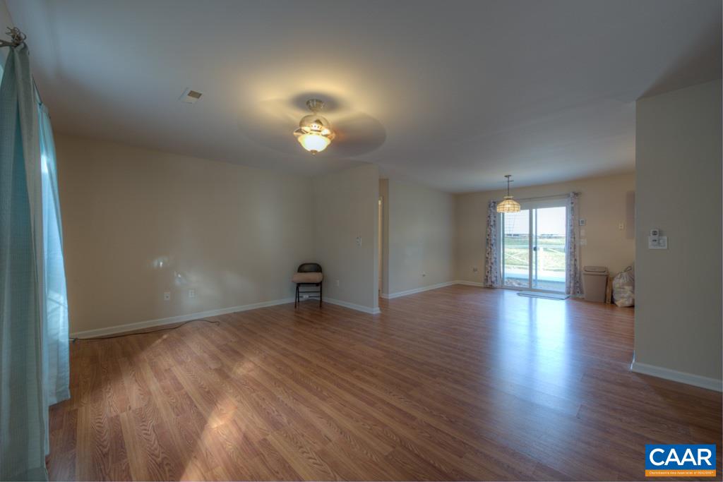 296 Morning Glory Road Ruckersville, VA 22968 - Photo 5 of 27 an empty room with wooden floor and windows