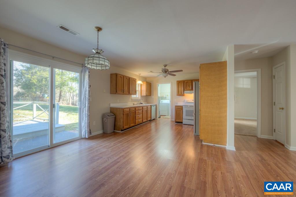 296 Morning Glory Road Ruckersville, VA 22968 - Photo 8 of 27 a view of a big room with wooden floor swimming pool and windows