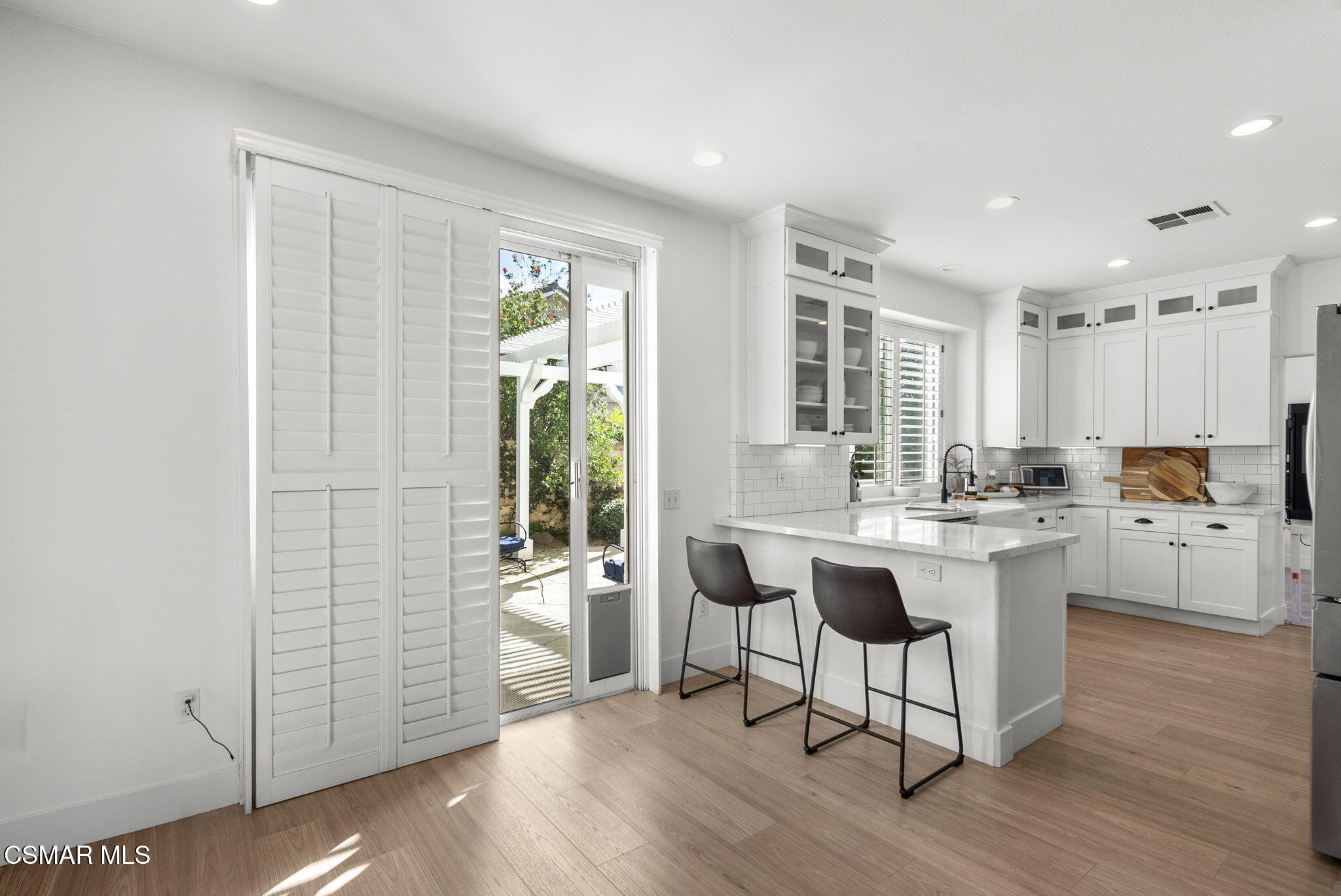 2648 Fallen Leaf Court Simi Valley, CA 93063 - Photo 15 of 42 a kitchen with white cabinets and wooden floor