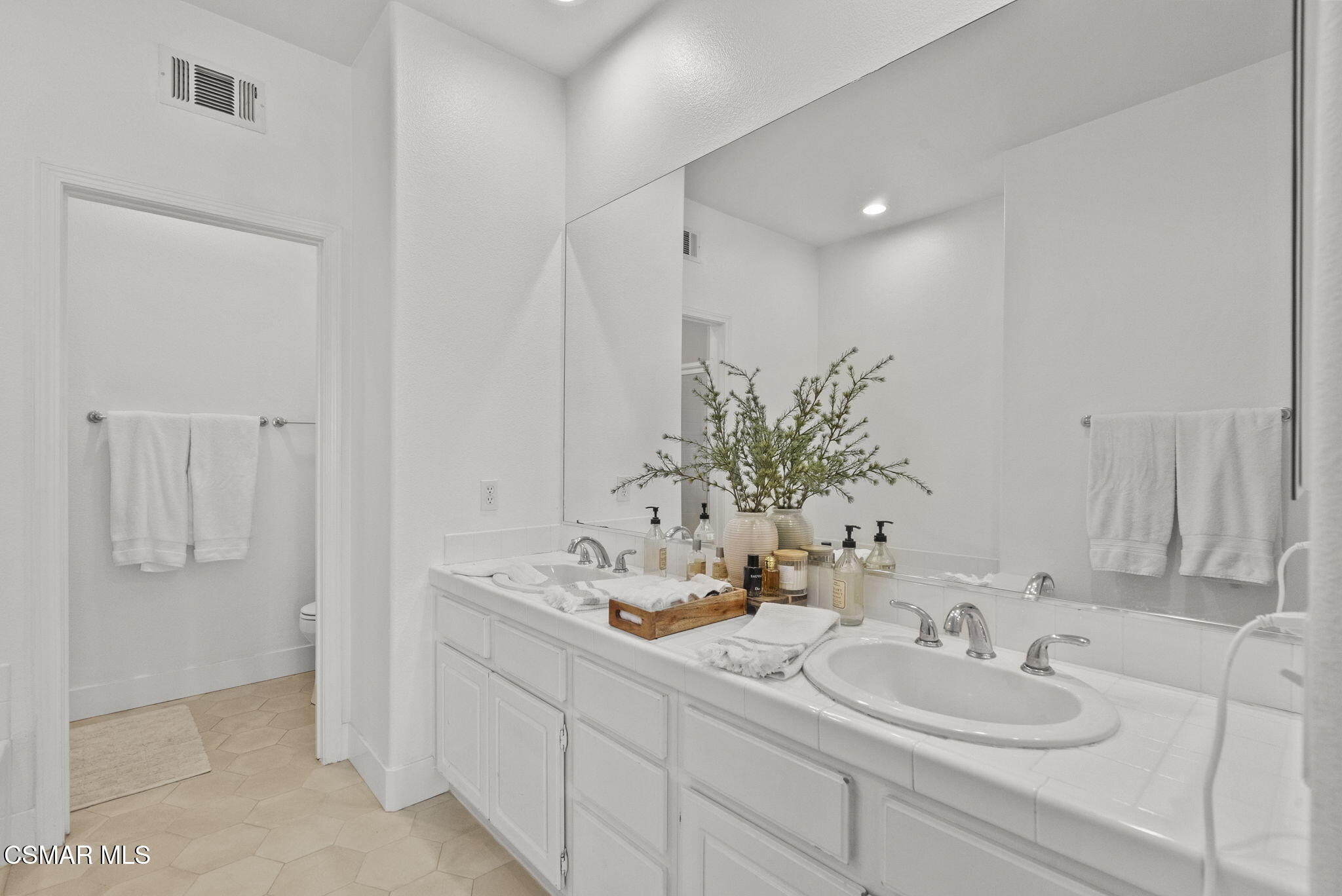 2648 Fallen Leaf Court Simi Valley, CA 93063 - Photo 33 of 42 a bathroom with double vanity sinks and a mirror