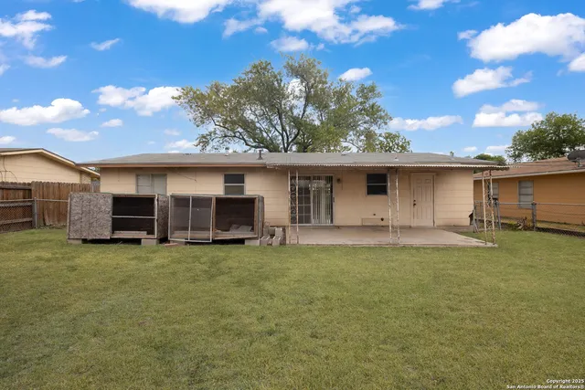 a view of a house with a yard and roof