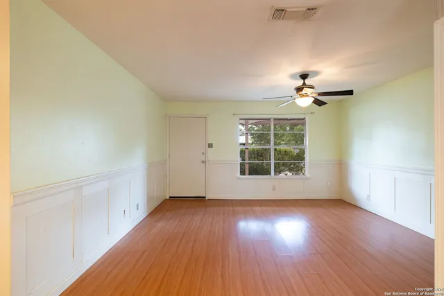 wooden floor in an empty room with a window