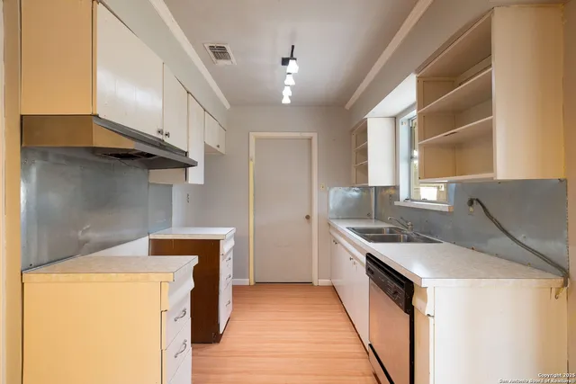 a kitchen that has a sink and a stove
