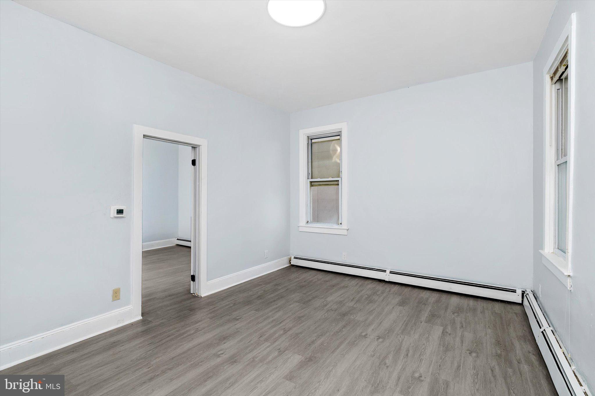 10 Lytle Street, Unit 2 Princeton, NJ 08542 - Photo 6 of 16 an empty room with wooden floor and windows
