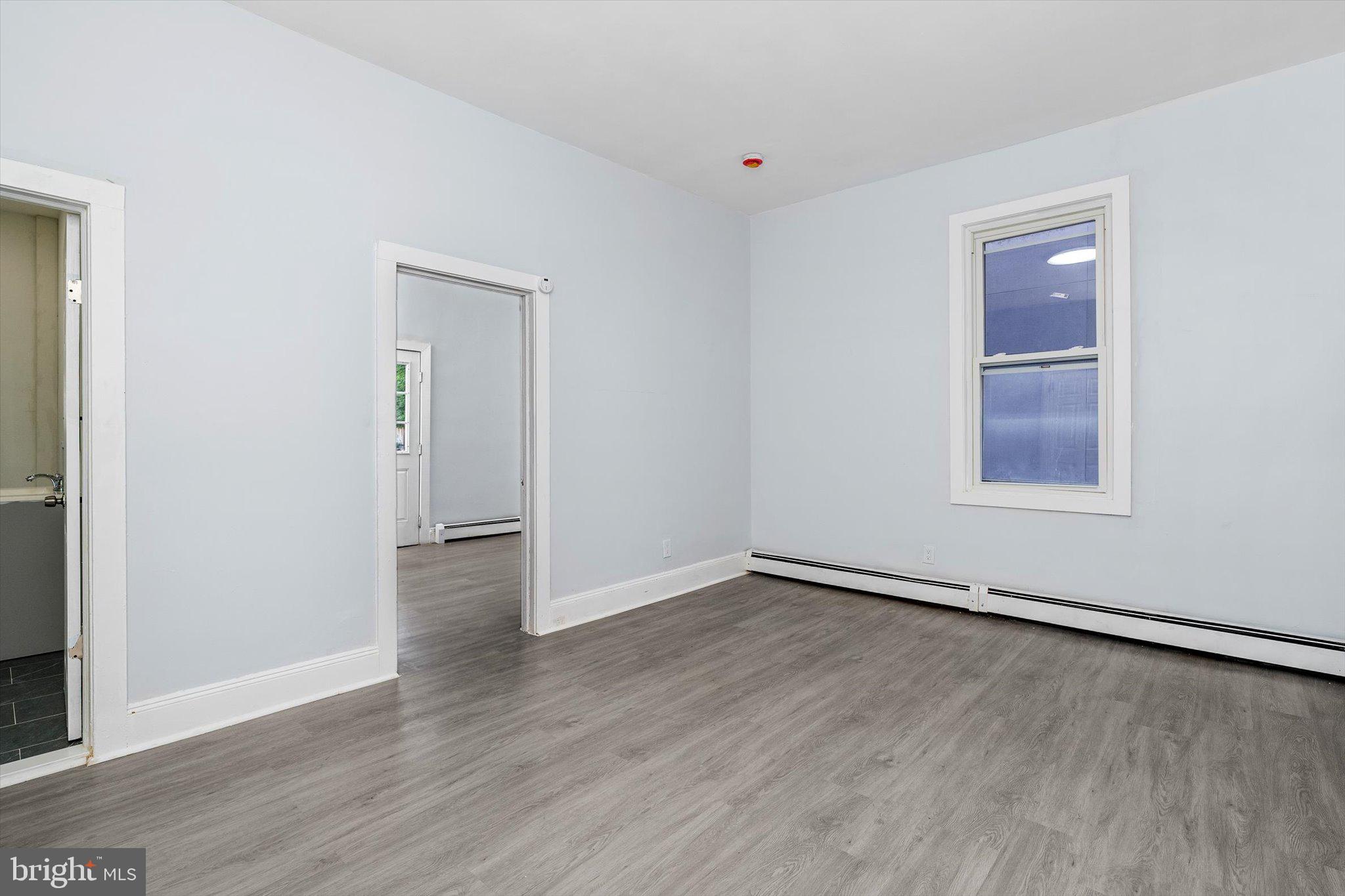 10 Lytle Street, Unit 2 Princeton, NJ 08542 - Photo 9 of 16 an empty room with wooden floor and windows
