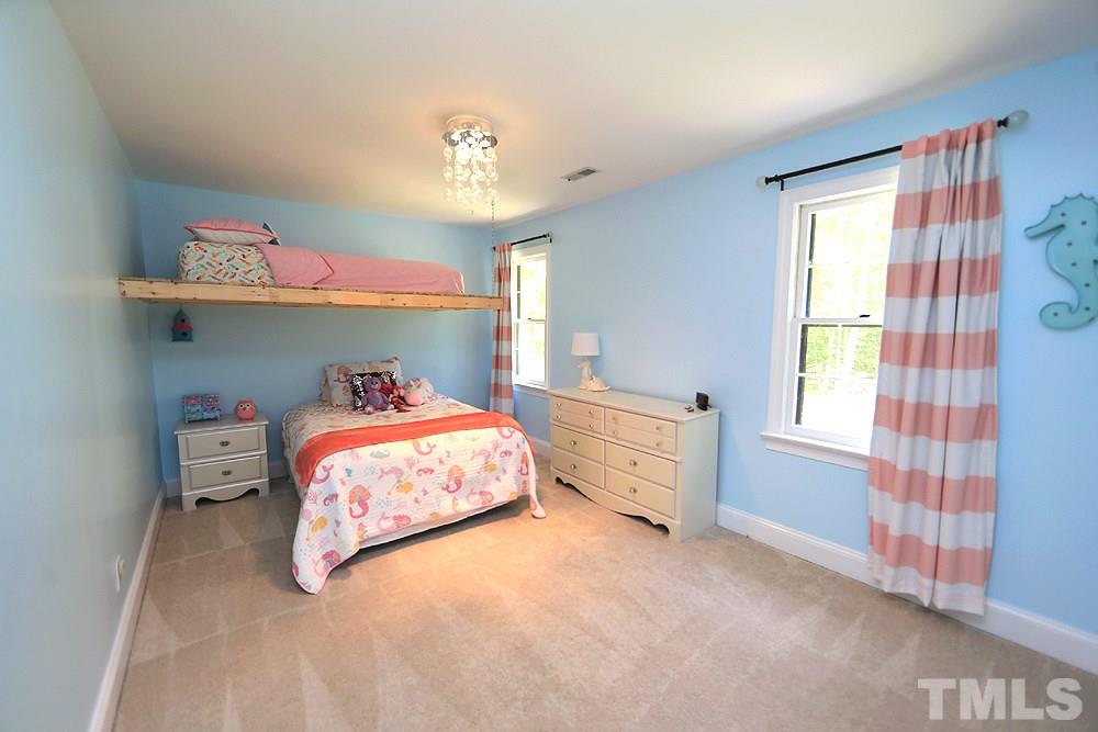 716 Bennington Drive Raleigh, NC 27615 - Photo 11 of 29 a bedroom with a bed and a window