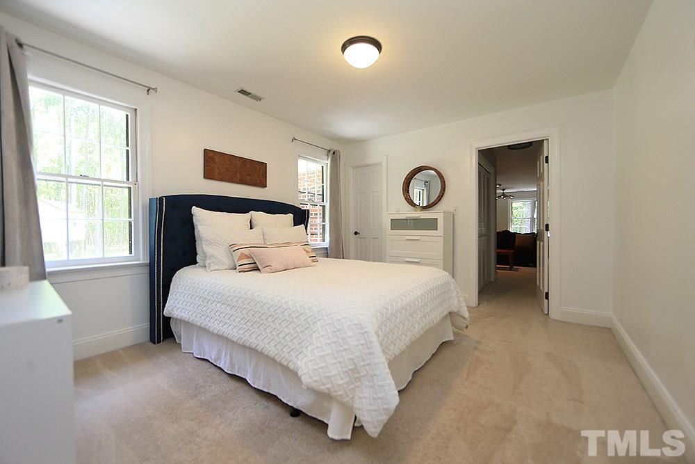 716 Bennington Drive Raleigh, NC 27615 - Photo 13 of 29 a bedroom with a bed and a window