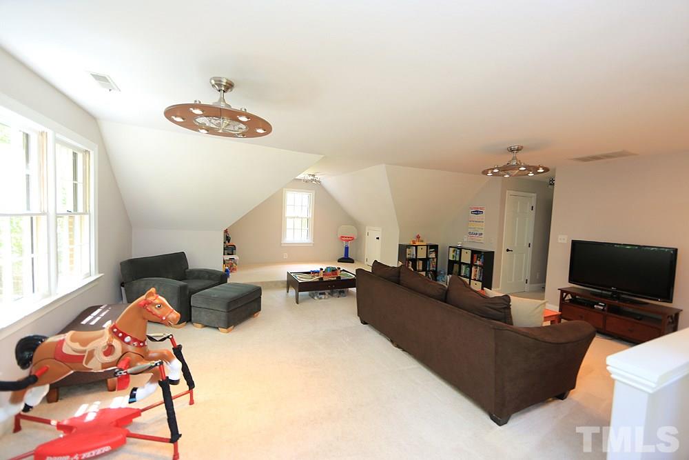 716 Bennington Drive Raleigh, NC 27615 - Photo 15 of 29 a living room with furniture and a flat screen tv