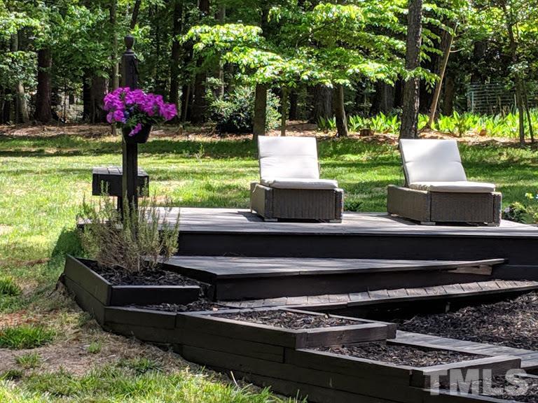 716 Bennington Drive Raleigh, NC 27615 - Photo 18 of 29 a front view of a house with a yard table and chairs