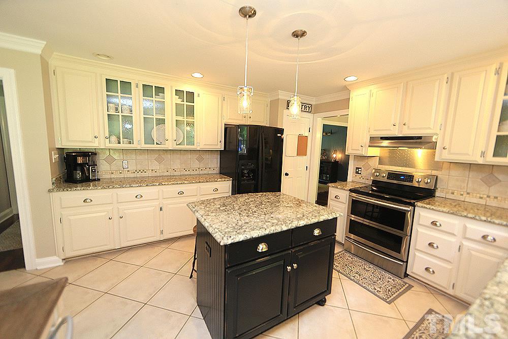 716 Bennington Drive Raleigh, NC 27615 - Photo 3 of 29 a kitchen with a sink stove and refrigerator