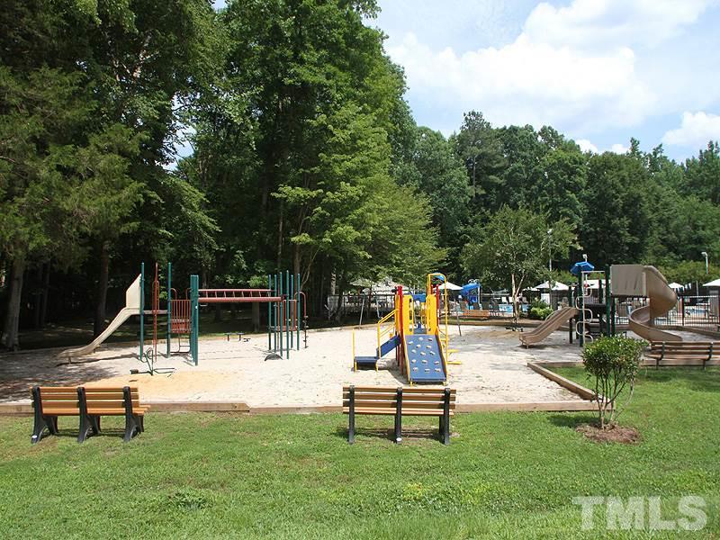 716 Bennington Drive Raleigh, NC 27615 - Photo 25 of 29 a park view with a bench and trees