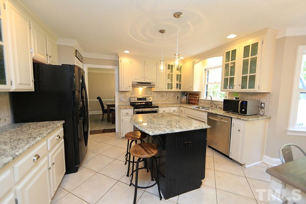716 Bennington Drive Raleigh, NC 27615 - Photo 4 of 29 a kitchen with a sink refrigerator and cabinets