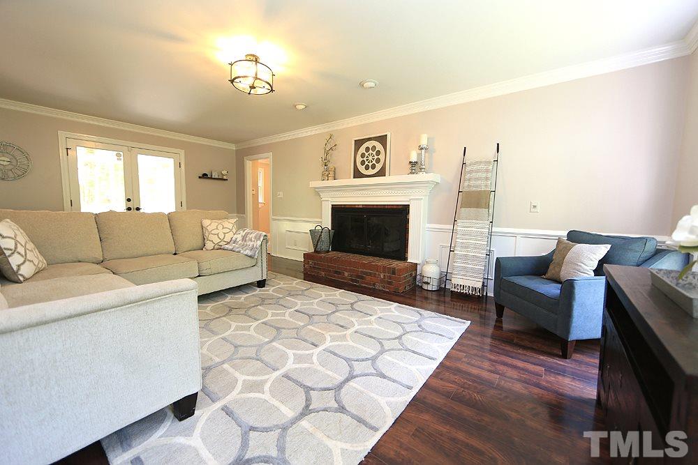 716 Bennington Drive Raleigh, NC 27615 - Photo 7 of 29 a living room with furniture and a fireplace