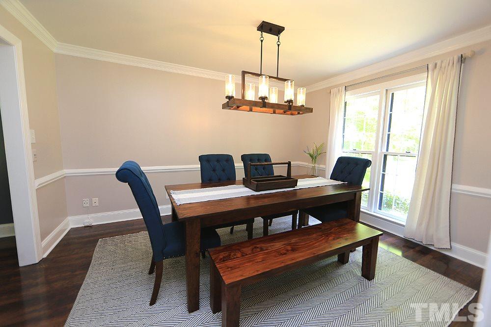 716 Bennington Drive Raleigh, NC 27615 - Photo 8 of 29 a view of a dining room with furniture window and wooden floor