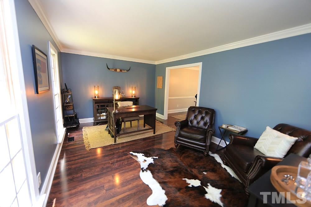 716 Bennington Drive Raleigh, NC 27615 - Photo 9 of 29 a living room with furniture and a fireplace