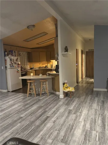 a kitchen with a refrigerator and a stove top oven